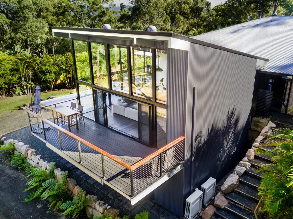 large double storey steel backyard liveable shed with balcony and floor to ceiling windows