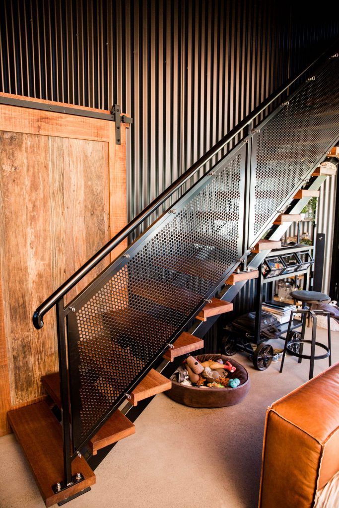 staircase with railing inside liveable shed house