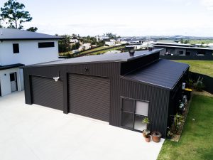 large residential black steel shed with basketball hoop