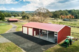 farm shed with tractor and caravan on rural property