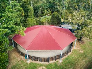 covered horse arena red roof aerial view