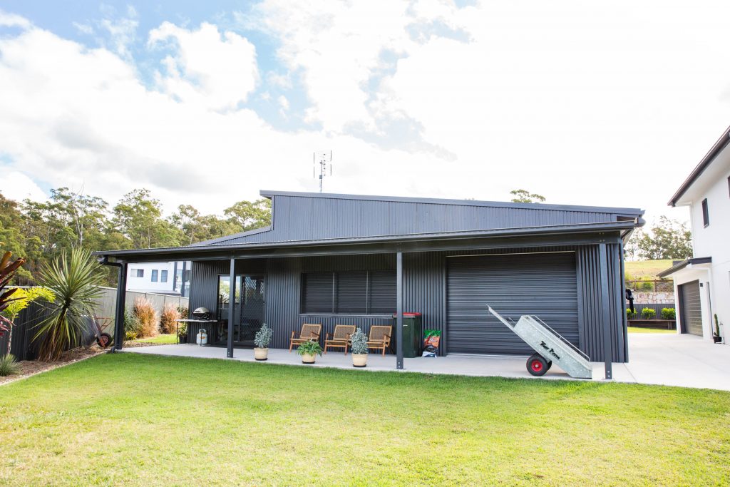 grey steel residential shed caboolture with slanted roof and covered patio